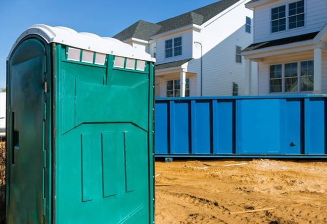 a row of portable toilets at a busy job site